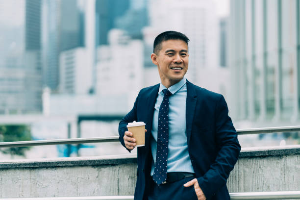istock Businessman leaning on bridge and drinking coffee 1150696409