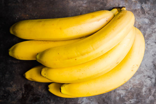 istock Branch of bananas on the rustic background 1150696778