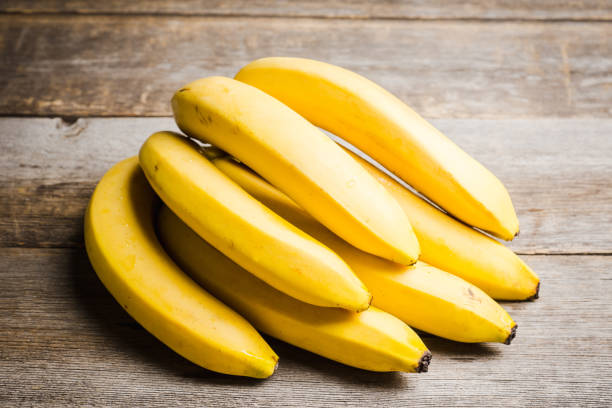 istock Branch of bananas on the rustic background 1150696792