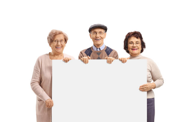istock Group of seniors holding a blank signboard 1150697729