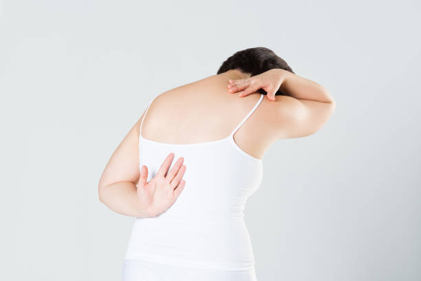 istock Back pain, woman with backache on gray background 1150697877