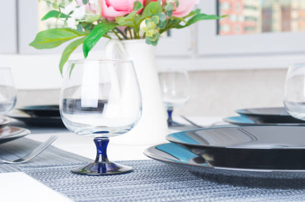 istock Kitchen white table served with plates, forks and glasses 1150698371
