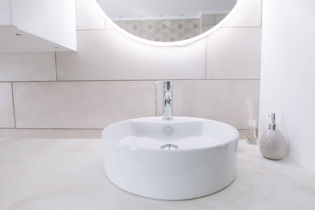 istock Minimalist bathroom with sink and mirror. Mirror with led backlight 1150698381