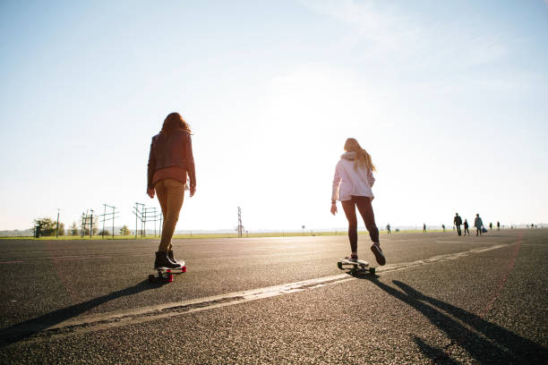 istock Berlin: young adults with skateboards on tempelhofer feld 1150698506
