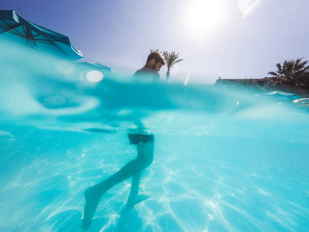 Man walking trough the swimming pool.