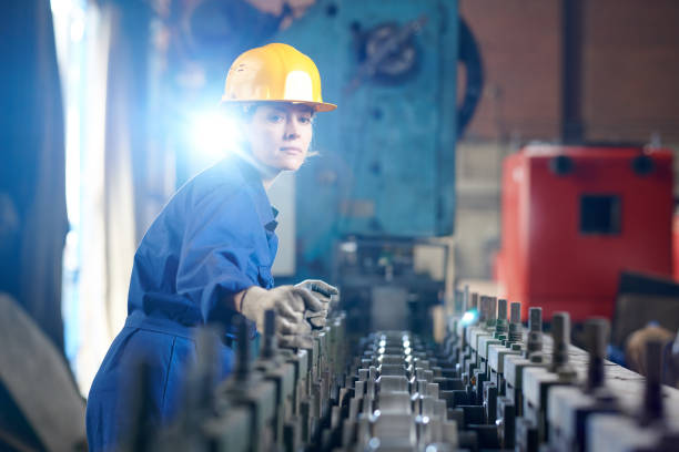 Waist up portrait of beautiful woman working at industril plant standing against bright light, copy space
