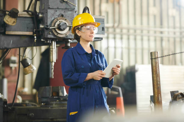 istock Smiling Woman Using Tablet at Factory 1150700079