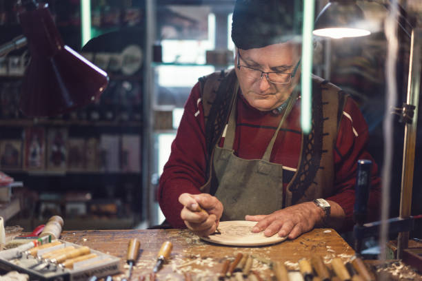 istock Senior adult carpenter working in his studio 1150700876