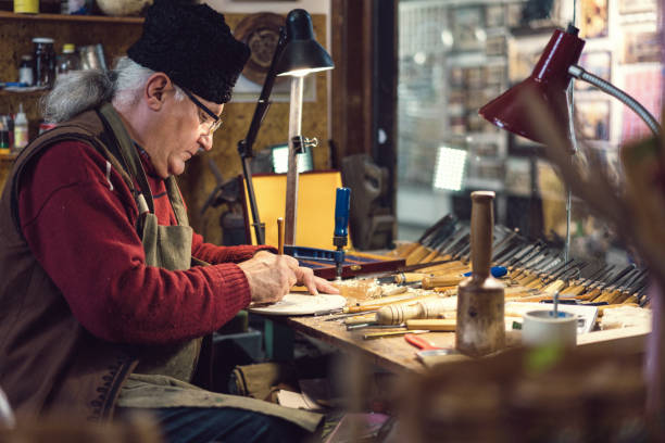 istock Senior adult artisan making decorative figurine 1150700878