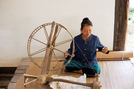 The spinning process involves twisting the fibers of the wool together to create a strong and durable thread for various textile applications.