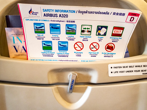 Safety card in back of seat on A320 waiting to take off from Bangkok International Airport.