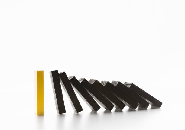 istock Domino effect stopped by unique strong piece 1150702312