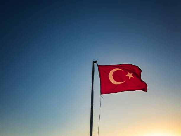 istock Turkish flag is waving against sky at the background 1150702877