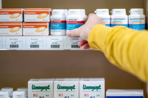 istock Man taking medicine bottle from shelf 1150706491