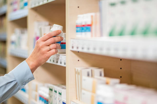 istock Woman's hand holding pill bottle 1150706530