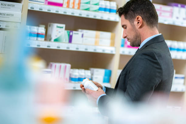 istock Man reading label of medicine bottle 1150706605