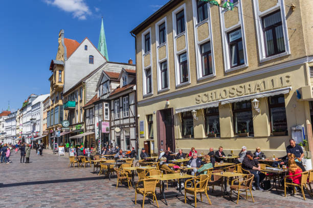 Schwerin, Germany - April 16, 2019: People enjoyng the spring sun at a cafe in Schwerin, Germany