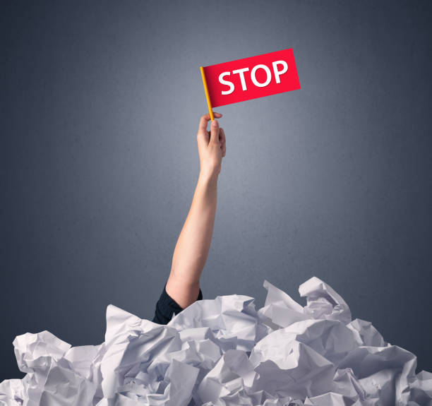 istock Female hand holding stop sign 1150707216