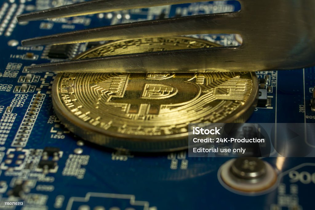 Coin Computer Chip A Single Bitcoin Coin On The Blue Computer Motherboard And Fork Trying ...