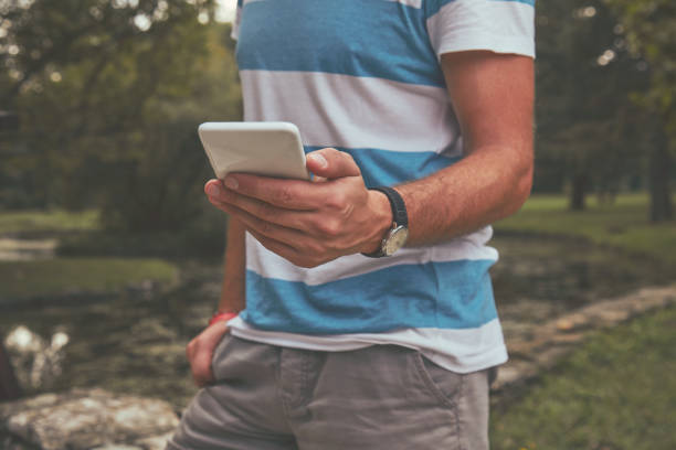 istock Trendy man using cellphone outdoors. 1150713146