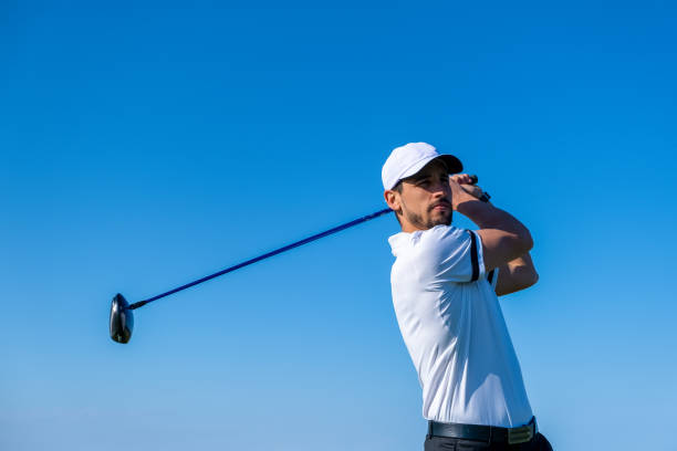 Golf player plays on a golf course stock photo