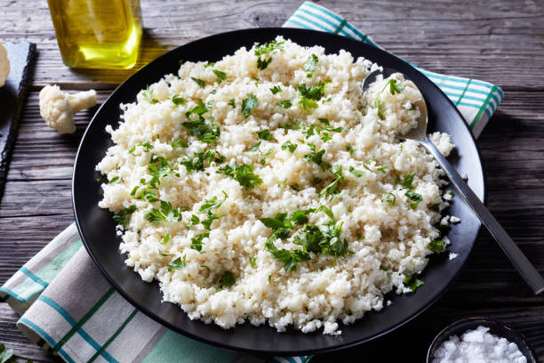 istock Cauliflower rice or couscous mixed with finely chopped parsley 1150715076