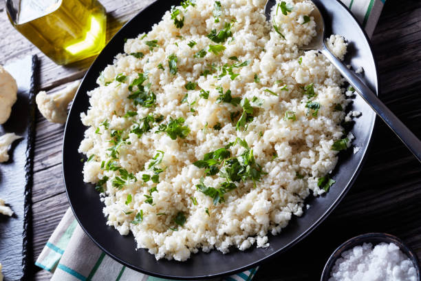 istock Cauliflower rice or couscous mixed with finely chopped parsley 1150715077