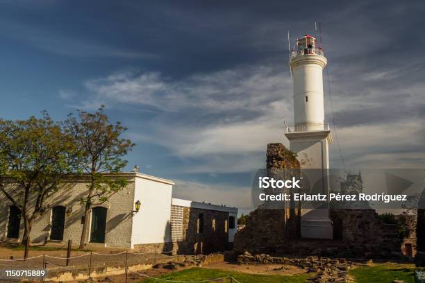 Lighthouse Of Colonia Del Sacramento In Uruguay With Ruin By Its Side Stock Photo - Download Image Now