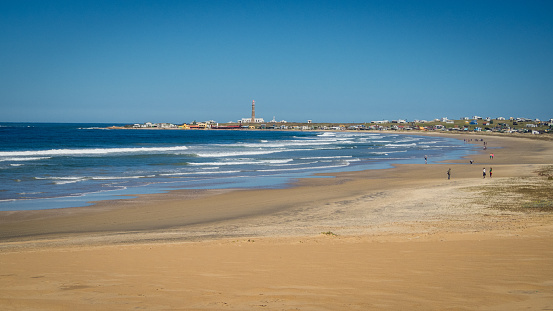 Vista panorámica del Parque Nacional de Cabo Polonio y su playa con el faro y casas de fondo, Uruguay photo