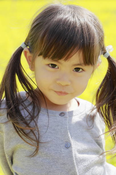 istock Japanese girl and field mustard (4 years old) 1150717264