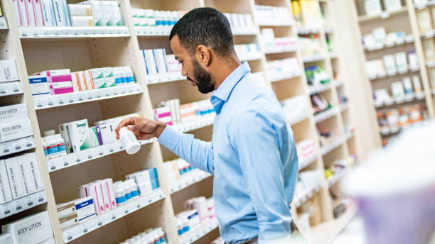 istock Man reading label of medicine bottle 1150717733