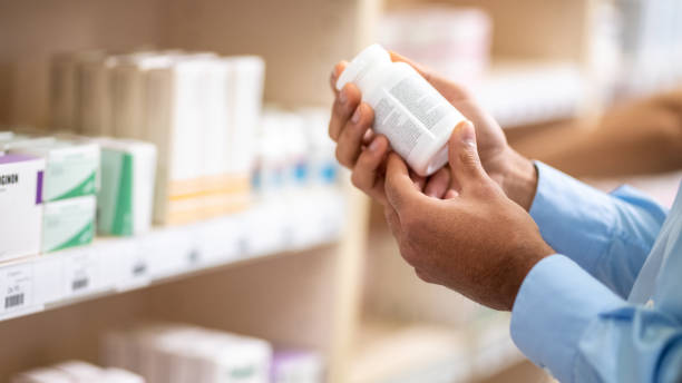 istock Man's hand holding medicine bottle 1150717758
