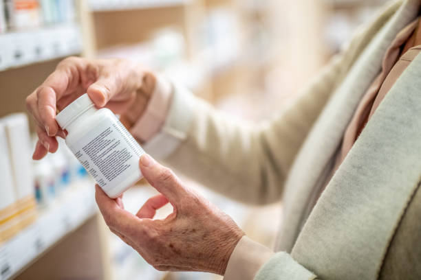istock Woman's hand holding medicine bottle 1150717759