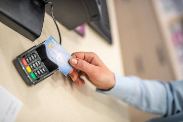 istock Pharmacist swiping credit card in credit card reader 1150717769