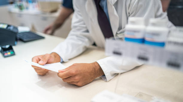 istock Male pharmacist holding prescription 1150717812