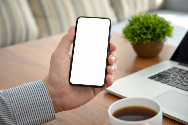 istock male hands holding phone with isolated screen in the office 1150718072