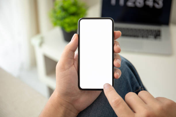 istock man hands holding phone with isolated screen in the room 1150718322