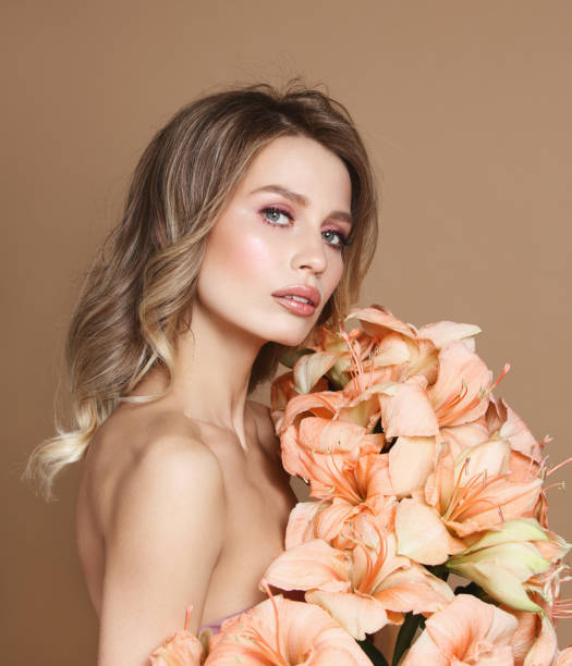 istock Beautiful young woman with flowers 1150719868