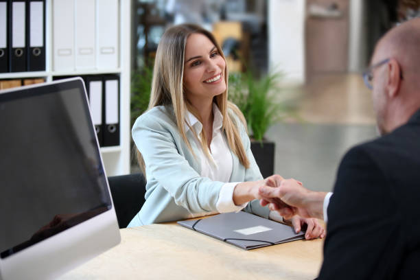 istock Young blonde woman extends hand to boss during job interview 1150720657