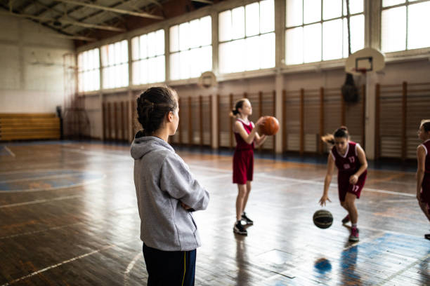 istock Female basketball trainer observing game on training 1150720662