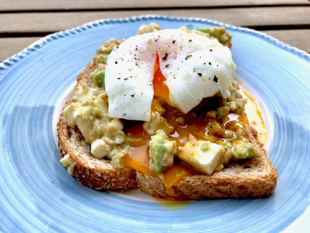 istock Homemade Poached Egg with Avocado Toast at Balcony Ready to Eat for Breakfast. 1150720876