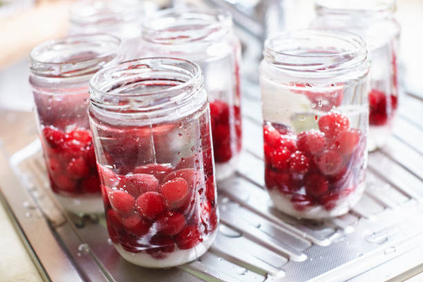 Homemade cherry compote canning in jars for winter in the kitchen