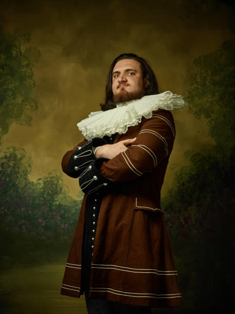 Young man as a medieval knight on dark background