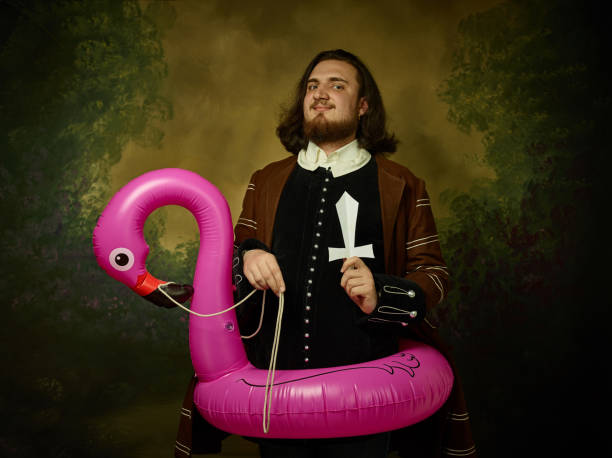 istock Young man as a medieval knight on dark background 1150722545