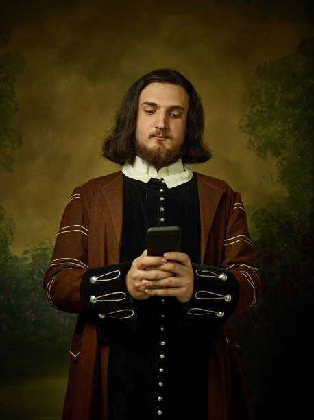 Young man as a medieval knight on dark background