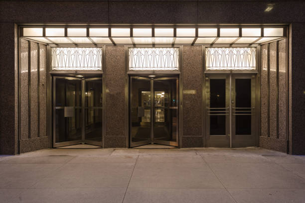 Decorative lights and architecture on front of downtown scraper entrance at night