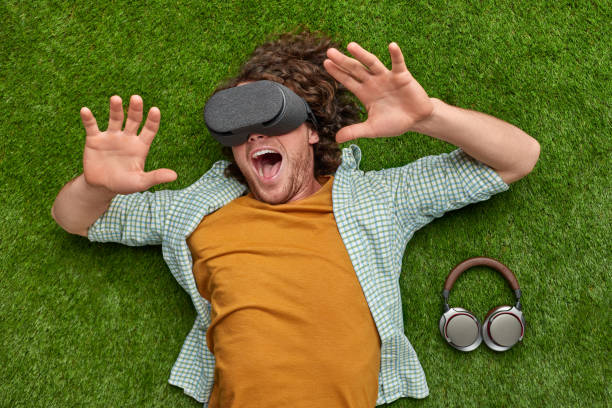 istock Excited man in VR glasses screaming on grass 1150723007