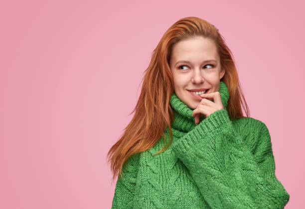 istock Charming flirty girl in green sweater 1150723043