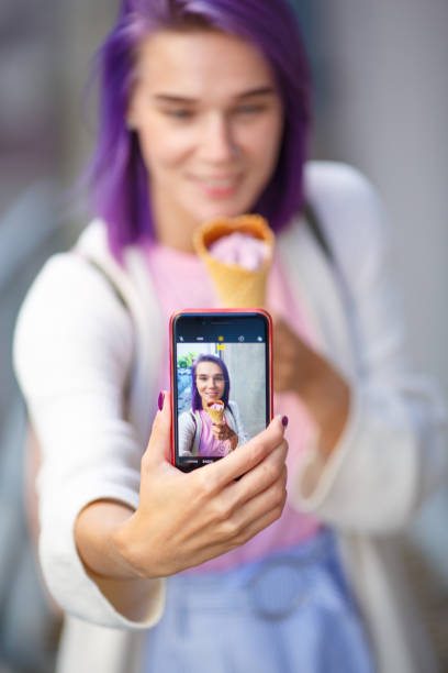 girl shows a photo on the phone stock photo