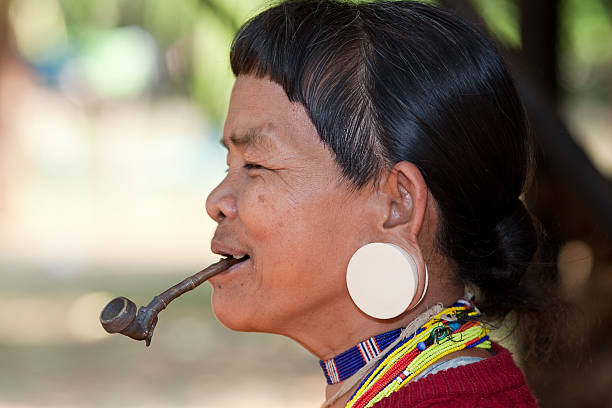 istock old woman with pipe in Asia 115072507